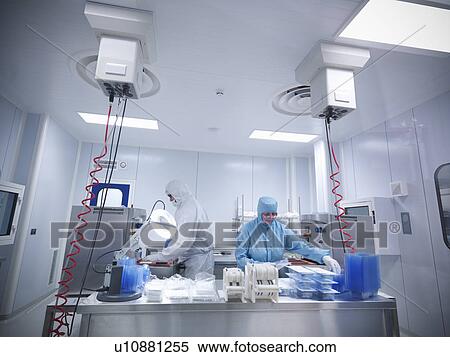 Stock Photography - Scientists work in laboratory clean room. Fotosearch