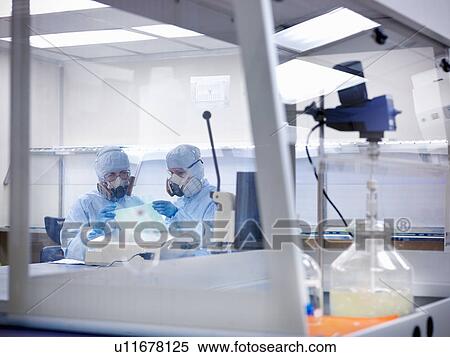 Stock Photography - Scientists working in clean room. Fotosearch