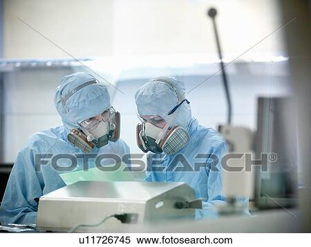 Stock Photography - Scientists working in clean room. Fotosearch
