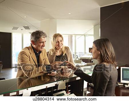Senior Couple Paying for a Hotel Room View Large Photo Image Picture - Senior Couple Paying for a Hotel Room. Fotosearch