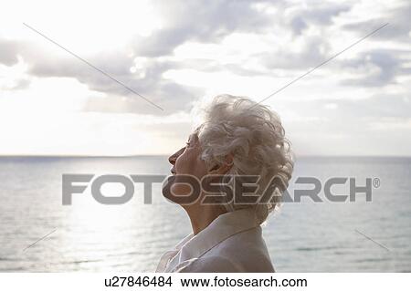 Picture - Senior Woman on the beach. Fotosearch