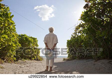 Senior Woman on the beach View Large Photo Image Picture - Senior Woman on the beach. Fotosearch