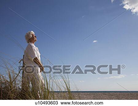 Stock Image - Senior Woman on the beach. Fotosearch