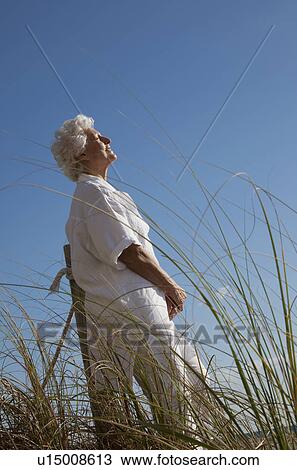 Stock Image - Senior Woman on the beach. Fotosearch