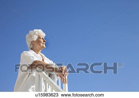 Stock Image - Senior Woman on the beach. Fotosearch