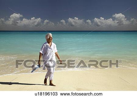 Senior Woman on the beach View Large Photo Image Stock Image - Senior Woman on the beach. Fotosearch