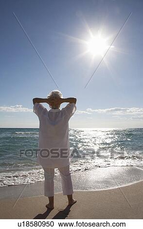 Stock Image - Senior Woman on the beach. Fotosearch