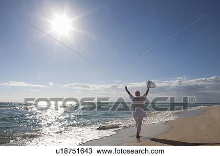 Stock Image - Senior Woman on the beach. Fotosearch