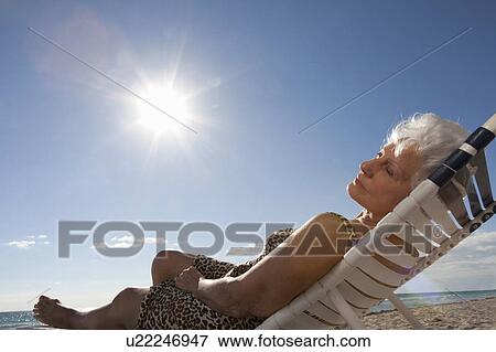 Stock Photo - Senior Woman on the beach. Fotosearch