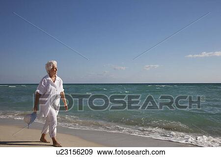 Stock Photo - Senior Woman on the beach. Fotosearch