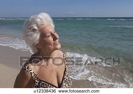 Senior Woman on the beach View Large Photo Image Stock Photograph - Senior Woman on the beach. Fotosearch