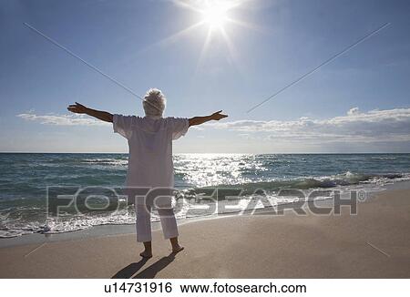 Stock Photograph - Senior Woman on the beach. Fotosearch