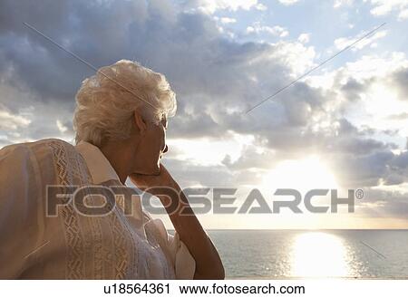 Senior Woman watching sunrise View Large Photo Image Stock Image - Senior Woman watching sunrise. Fotosearch