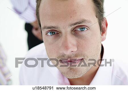 Stock Image - Serious businessman looks to camera. Fotosearch
