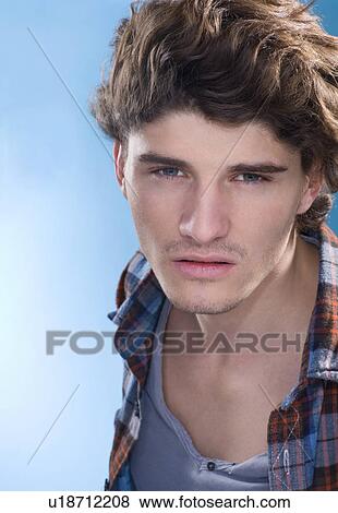 Stock Photo - Serious young man portrait. Fotosearch