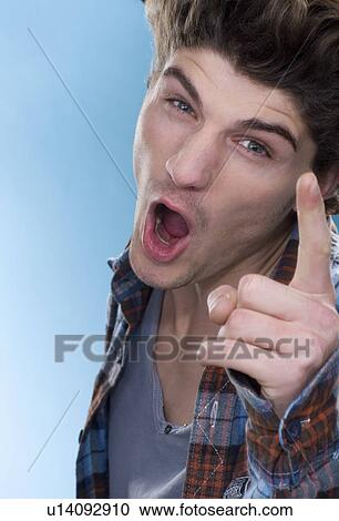 Stock Image - Shouting with pointed finger man. Fotosearch