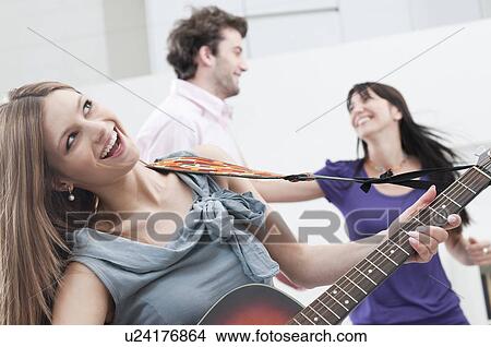 Picture - Singing and playing guitar. Fotosearch