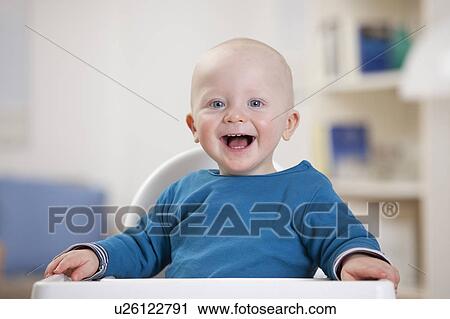 Smiling baby boy sitting in high chair View Large Photo Image Stock Image - Smiling baby boy sitting in high chair. Fotosearch