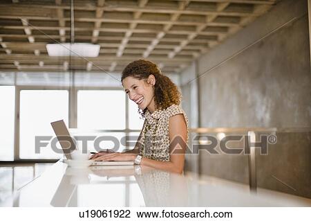 Smiling businesswoman using laptop View Large Photo Image Stock Image - Smiling businesswoman using laptop. Fotosearch