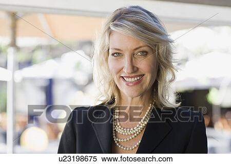 Smiling businesswoman wearing pearls View Large Photo Image Stock Photography - Smiling businesswoman wearing pearls. Fotosearch
