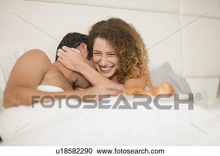 Smiling couple having breakfast in bed View Large Photo Image Stock Image - Smiling couple having breakfast in bed. Fotosearch