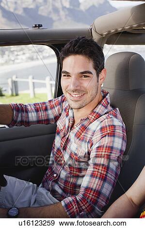 Smiling man driving jeep View Large Photo Image Stock Photo - Smiling man driving jeep. Fotosearch