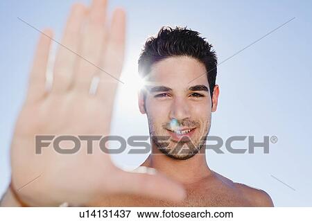 Smiling man holding up hand View Large Photo Image Stock Photo - Smiling man holding up hand. Fotosearch