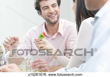 Smiling man pouring fresh water in glass View Large Photo Image Stock Photograph - Smiling man pouring fresh water in glass. Fotosearch