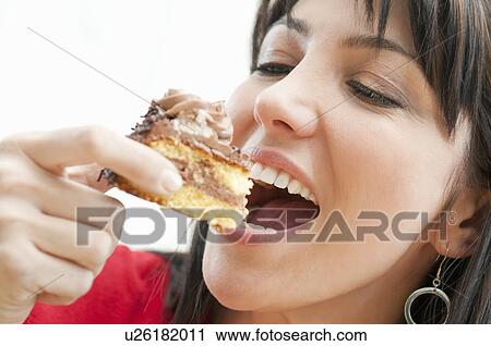 Smiling woman eating chocolate cake View Large Photo Image Stock Image - Smiling woman eating chocolate cake. Fotosearch