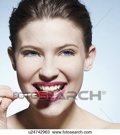 Smiling woman eating lollipop View Large Photo Image Stock Image - Smiling woman eating lollipop. Fotosearch