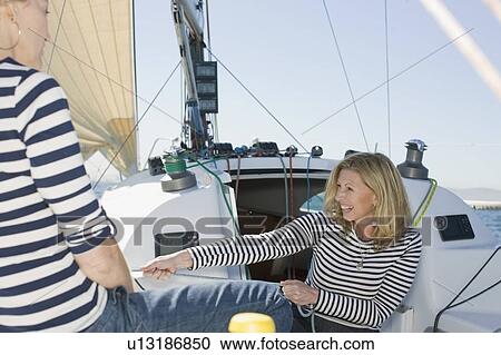 Smiling woman pulling rope on boat View Large Photo Image Stock Image - Smiling woman pulling rope on boat. Fotosearch