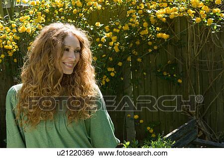 Smiling woman standing outside View Large Photo Image Stock Photo - Smiling woman standing outside. Fotosearch