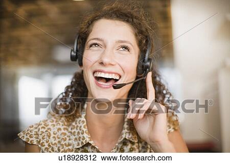 Smiling woman wearing headset View Large Photo Image Stock Image - Smiling woman wearing headset. Fotosearch