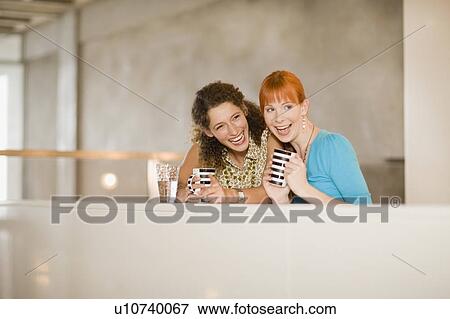 Smiling women having coffee together View Large Photo Image Stock Photo - Smiling women having coffee together. Fotosearch