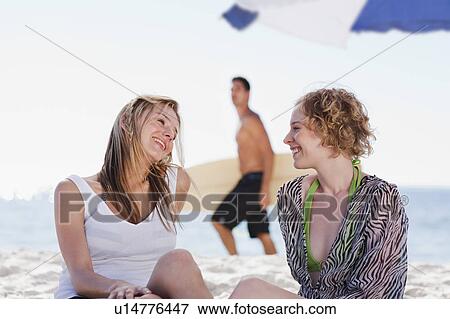 Smiling women talking on beach View Large Photo Image Stock Photo - Smiling women talking on beach. Fotosearch