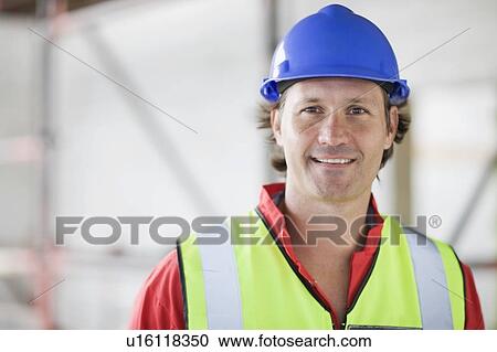 Stock Image - Smiling worker with hat. Fotosearch