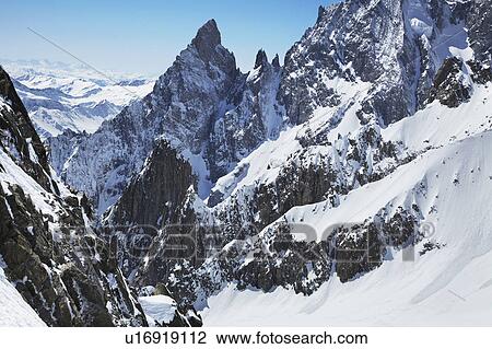 Snow covered mountains and blue sky View Large Photo Image Stock Image - Snow covered mountains and blue sky. Fotosearch