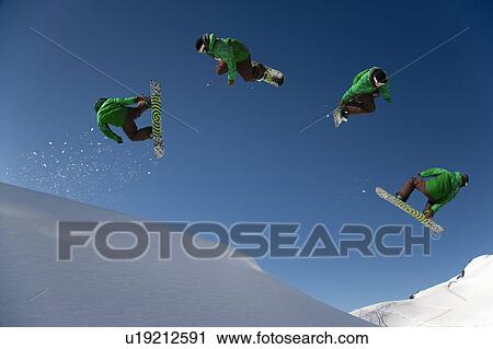 Stock Image - Snowboarder dangerous free ride jump. Fotosearch