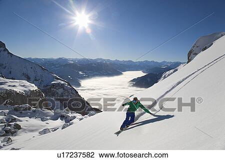 Snowboarder free riding View Large Photo Image Stock Image - Snowboarder free riding. Fotosearch