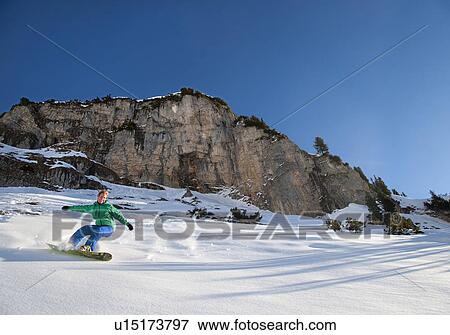 Snowboarder free riding View Large Photo Image Stock Photo - Snowboarder free riding. Fotosearch