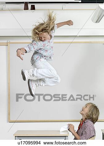 Picture - Student jumping on a bench. Fotosearch