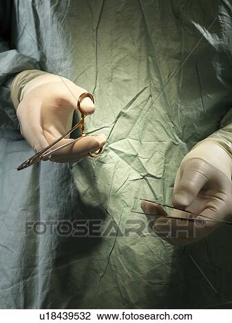 Stock Image - Surgeon with instruments. Fotosearch