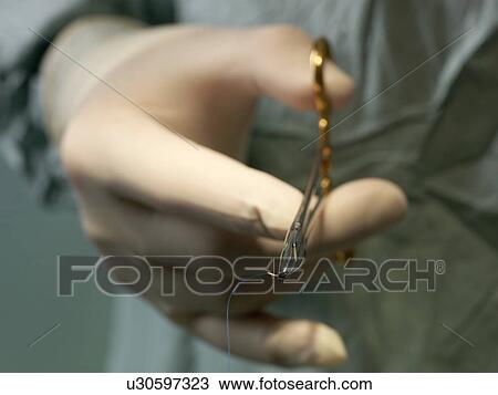 Stock Image - Surgical needle, close-up. Fotosearch