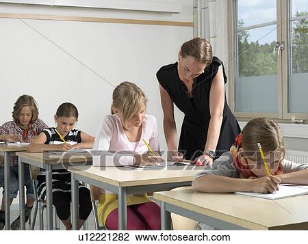 Teacher and students in a classroom View Large Photo Image Stock Image - Teacher and students in a classroom. Fotosearch
