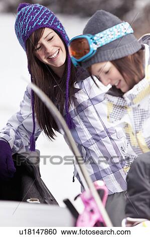 Teen girls by car with snowboard View Large Photo Image Stock Image - Teen girls by car with snowboard. Fotosearch