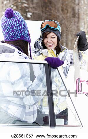 Teen girls by car with snowboard View Large Photo Image Stock Photo - Teen girls by car with snowboard. Fotosearch