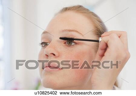Teenage girl applying mascara View Large Photo Image Stock Image - Teenage girl applying mascara. Fotosearch