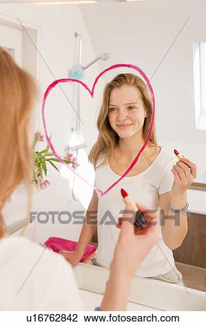 Teenage girl drawing heart in lipstick View Large Photo Image Stock Image - Teenage girl drawing heart in lipstick. Fotosearch