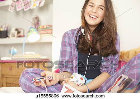 teenage girl listening to music in pajamas View Large Photo Image Stock Photograph - teenage girl listening to music in pajamas. Fotosearch