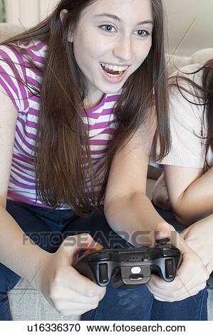 teenage girl playing a video game View Large Photo Image Stock Image - teenage girl playing a video game. Fotosearch